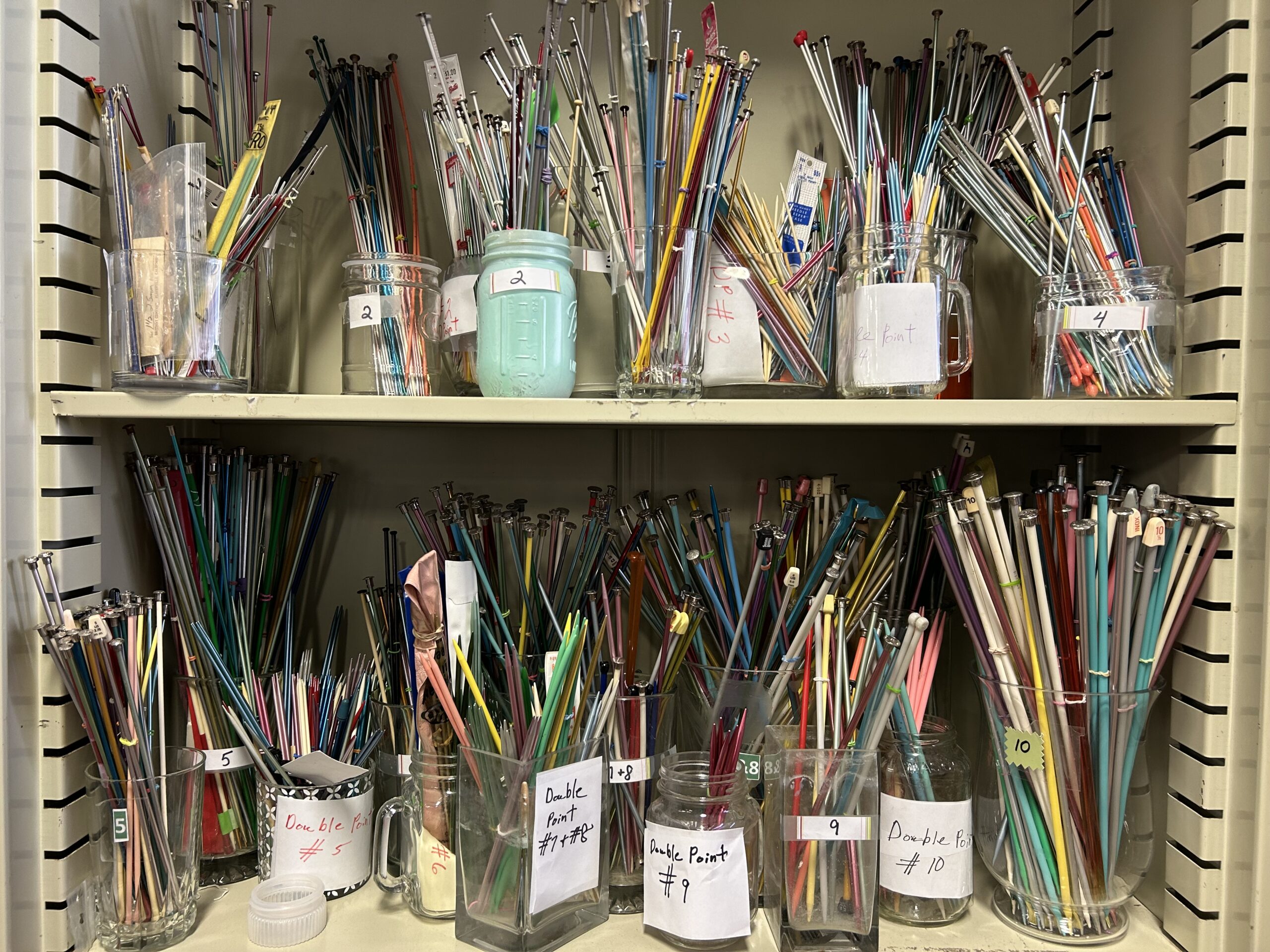 Jars of secondhand art supplies.