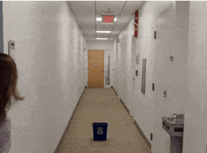 Animated picture showing a person throwing a cup into a recycling bin.